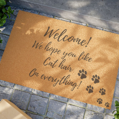 Felpudo de bienvenida: "Esperamos que te guste el pelo de gato en todo". Felpudo con diseño de pata de gato.